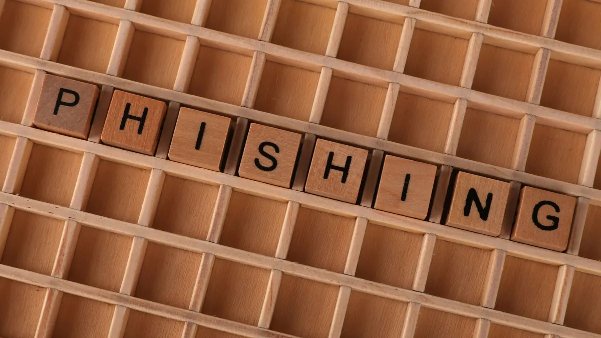 Wooden letter tiles spelling the word phishing