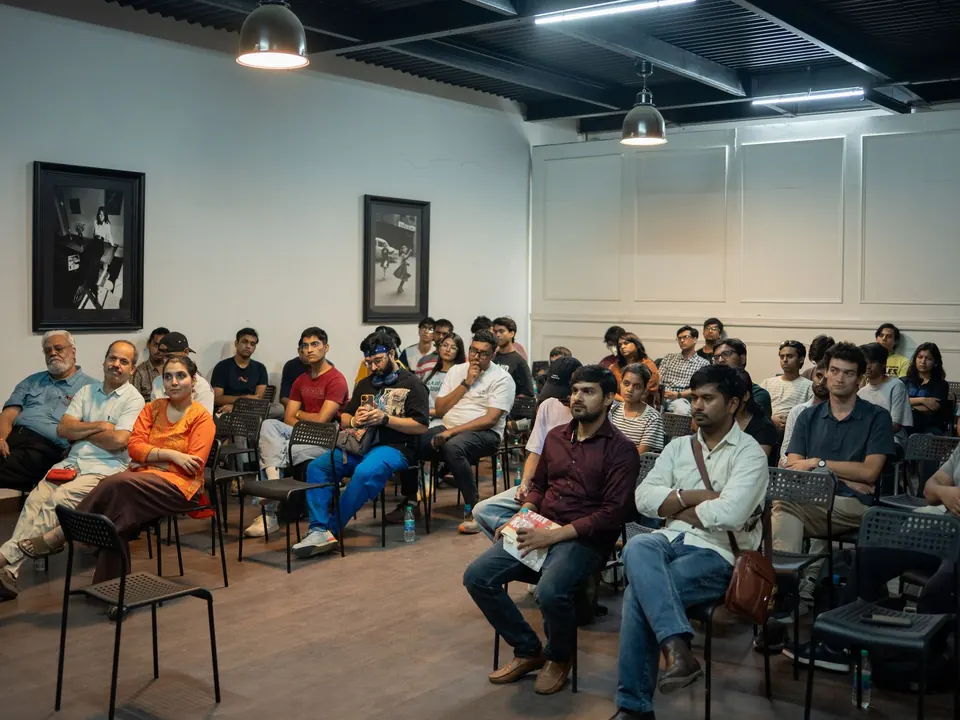 Members of the public seated in a hall, listening to a talk